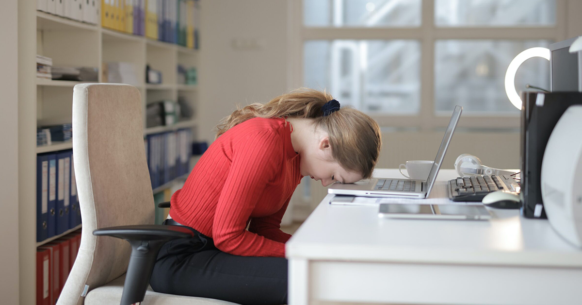 Hero image of dejected employee with head on desk